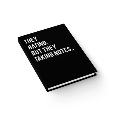 Student workspace: ART WE ALL Sassy Note-Taking journal next to laptop and sketchpad  bold and confident design